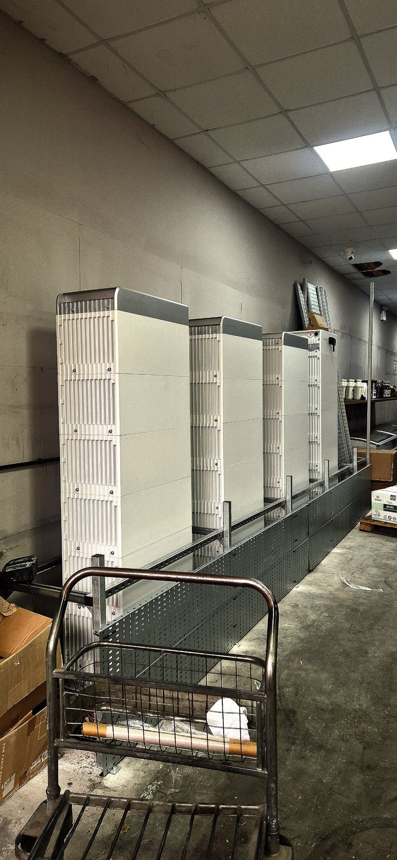 Battery units standing on new galvanised cable tray along the wall