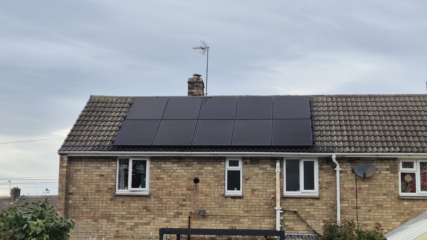 Ten all-black solar panels on the rear roof of a brick semi-detached house in Everthorpe